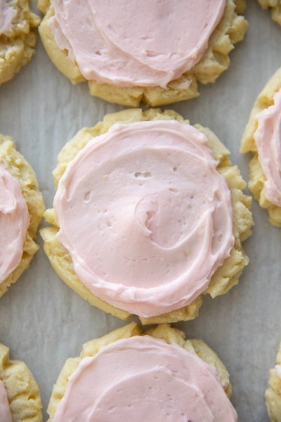 Thick, soft and sweet, you will DIE over how good these Copycat Swig Sugar Cookies are! These pressed cookies are made with really common pantry ingredients, are softly baked to keep them tender and frosted with a light pink buttercream