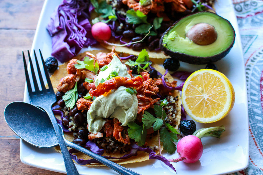Build a better taco with these flavorful, healthy 100% plant-based tacos, which includes a spicy jackfruit filling, protein-rich black beans, high-fiber quinoa, crunchy cabbage, and a fluffy avocado crema